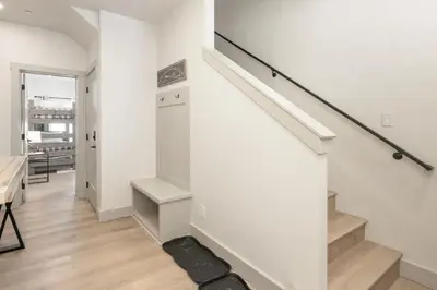 a white staircase in a living room with a stair case at Modern Granby Wonder by Leavetown Vacations in Granby