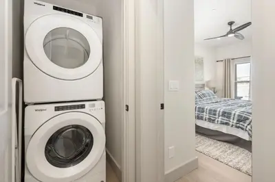 a washer and dryer in a room with a bedroom at Modern Granby Wonder by Leavetown Vacations in Granby