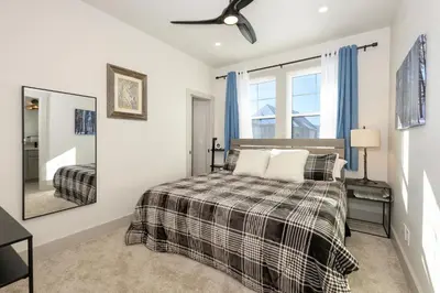 a bedroom with a bed and a ceiling fan at Modern Granby Wonder by Leavetown Vacations in Granby