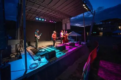 a group of people on a stage at night at Modern Granby Wonder by Leavetown Vacations in Granby