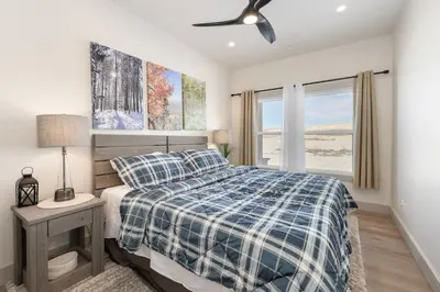 a bedroom with a bed and a ceiling fan at Modern Granby Wonder by Leavetown Vacations in Granby