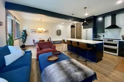a living room with a blue couch and a kitchen at Seasons 1889 - Keystone in Keystone