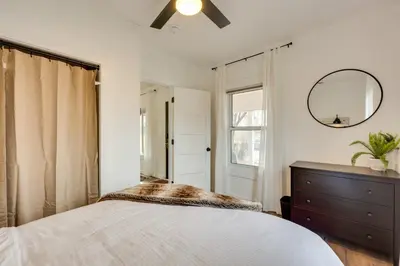 a bedroom with a bed and a mirror and a dresser at Chic Erie Vacation Rental about 14 Mi to Boulder! in Erie