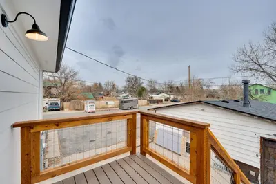a wooden balcony with a view of a yard at Chic Erie Vacation Rental about 14 Mi to Boulder! in Erie