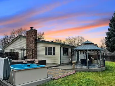 a house with a pool and a gazebo at ᨒFIREHAUSᨒHotTubᨒCinemaᨒBBQᨒBadmintonᨒGames in Arvada