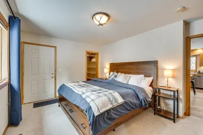a bedroom with a large bed with a wooden headboard at Less Than half Mi to Marina Grand Lake Getaway! in Grand Lake
