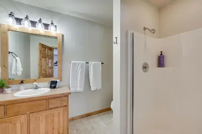 a bathroom with a sink and a mirror and a shower at Less Than half Mi to Marina Grand Lake Getaway! in Grand Lake