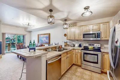 a kitchen with wooden cabinets and stainless steel appliances at Mountain Vista in Fraser