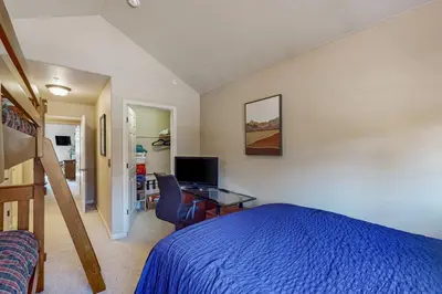 a bedroom with a bed and a desk with a computer at Mountain Vista in Fraser