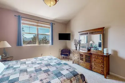 a bedroom with a bed and a dresser and a mirror at Mountain Vista in Fraser