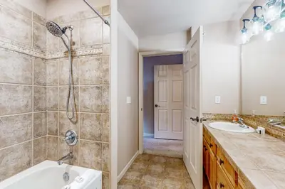 a bathroom with a tub and a shower and a sink at Mountain Vista in Fraser