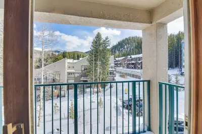 a balcony with a view of a snow covered street at Ski-InandSki-Out Winter Park Condo with Mountain Views in Winter Park