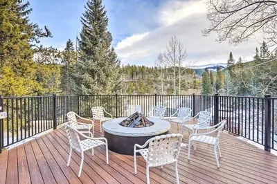 a patio with chairs and a fire pit on a deck at Ski-InandSki-Out Winter Park Condo with Mountain Views in Winter Park
