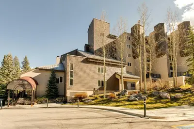 a large house with a tower on top of it at Ski-InandSki-Out Winter Park Condo with Mountain Views in Winter Park
