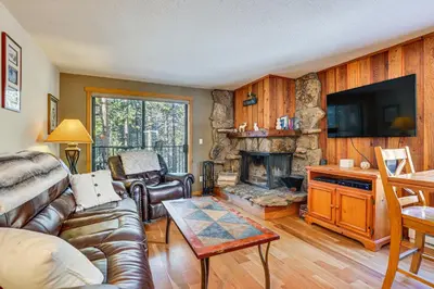 a living room with a couch and a fireplace at Colorado Condo about 2 Mi to Winter Park Resort! in Winter Park