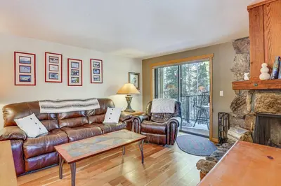 a living room with a leather couch and a fireplace at Colorado Condo about 2 Mi to Winter Park Resort! in Winter Park