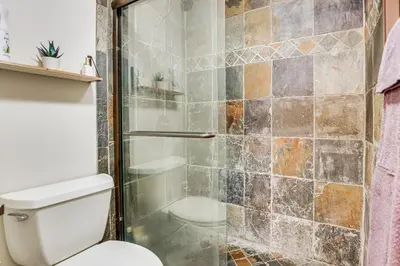 a bathroom with a shower with a toilet at Colorado Condo about 2 Mi to Winter Park Resort! in Winter Park