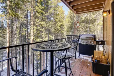 a balcony with a table and chairs and a grill at Colorado Condo about 2 Mi to Winter Park Resort! in Winter Park