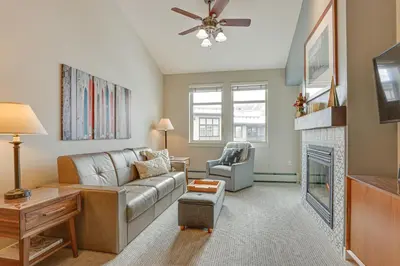 a living room with a couch and a fireplace at Ski-InandSki-Out Winter Park Condo with Hot Tub Access in Winter Park
