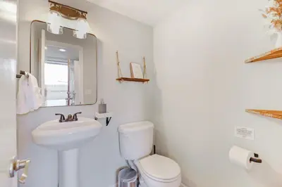 a white bathroom with a toilet and a sink at Comfy Family-size Townhome 2BR-5 People near Old town Arvada-10min walk in Arvada