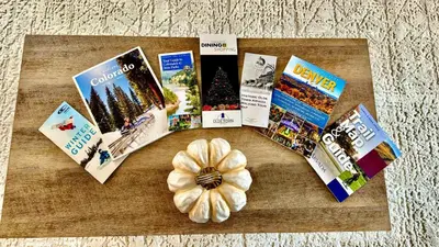 a bunch of books and a flower on a table at Comfy Family-size Townhome 2BR-5 People near Old town Arvada-10min walk in Arvada