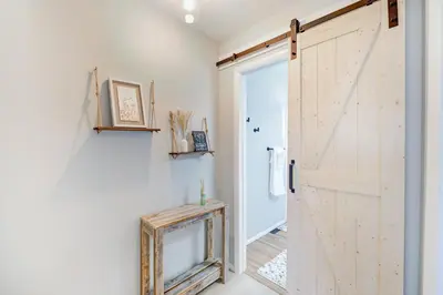 a sliding barn door in a room with a hallway at Comfy Family-size Townhome 2BR-5 People near Old town Arvada-10min walk in Arvada
