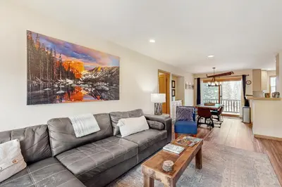a living room with a couch and a table at Cabin Sweet Cabin in Winter Park