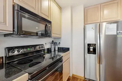 a kitchen with a stainless steel refrigerator and a microwave at Cabin Sweet Cabin in Winter Park