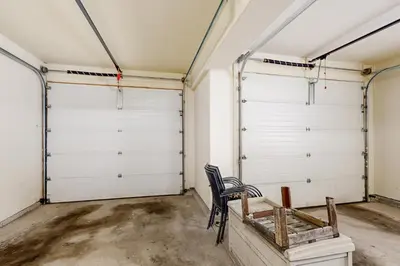 two garage doors in a room with a chair at Cabin Sweet Cabin in Winter Park