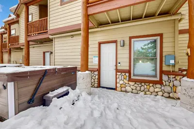 a house in the snow with a front door at Cabin Sweet Cabin in Winter Park