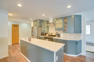 a kitchen with blue cabinets and a white counter top at 6 Mi to Staunton State Park Conifer Home with Deck in Conifer