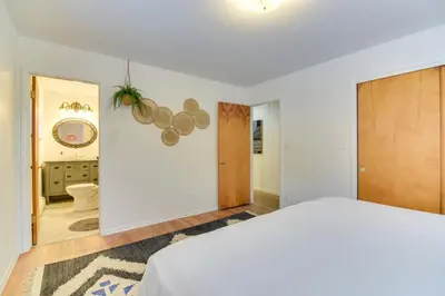 a white bedroom with a bed and a hallway at 6 Mi to Staunton State Park Conifer Home with Deck in Conifer