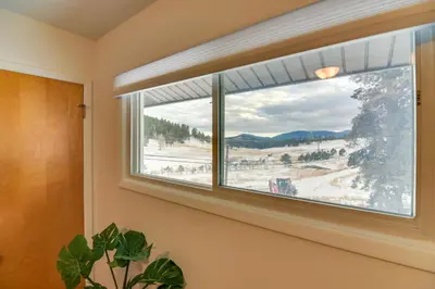a window with a view of a snow covered field at 6 Mi to Staunton State Park Conifer Home with Deck in Conifer