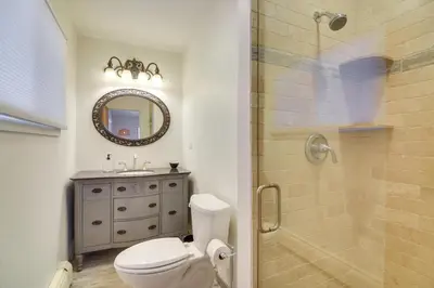a bathroom with a toilet and a shower with a mirror at 6 Mi to Staunton State Park Conifer Home with Deck in Conifer