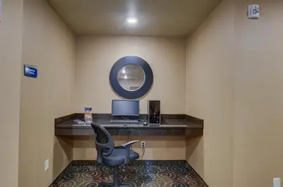 a room with a desk with a chair and a computer at Cobblestone Inn & Suites-Kersey in Kersey