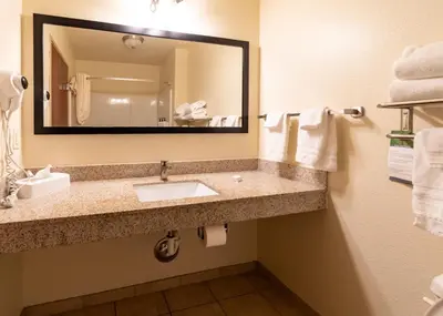 a bathroom with a sink and a mirror at Cobblestone Inn and Suites - Eaton in Eaton