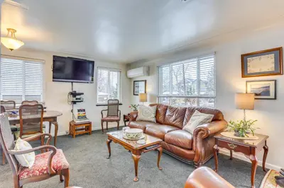 a living room with a leather couch and a table at Dog-Friendly Denver Apartment with Shared Yard! in Denver