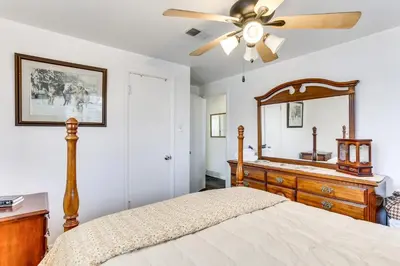 a bedroom with a bed with a dresser and a mirror at Dog-Friendly Denver Apartment with Shared Yard! in Denver