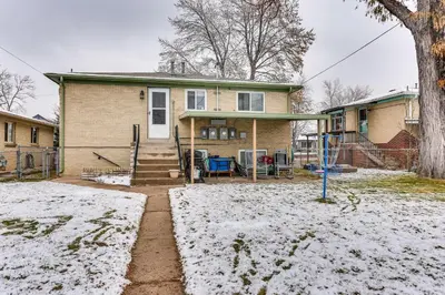 a house with snow on the ground in front of it at Dog-Friendly Denver Apartment with Shared Yard! in Denver