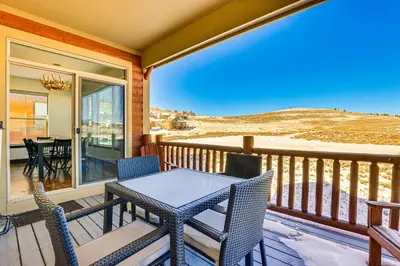 a patio with a table and chairs on a balcony at Half-Mi to Skiing Gorgeous Granby Ranch Home! in Granby