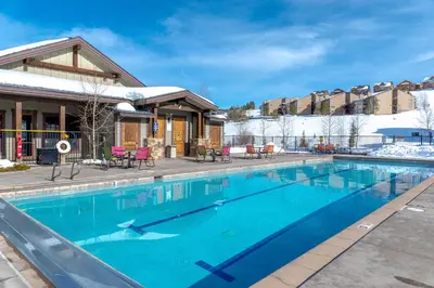 a swimming pool in front of a building at Half-Mi to Skiing Gorgeous Granby Ranch Home! in Granby