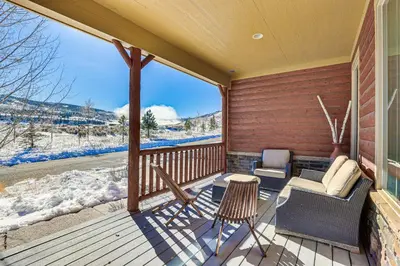 a porch with a couch and chairs on a deck with snow at Half-Mi to Skiing Gorgeous Granby Ranch Home! in Granby