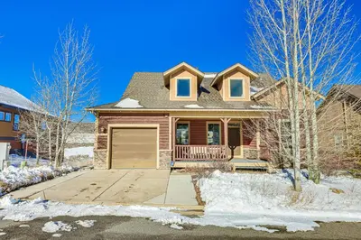 a house with a garage in the snow at Half-Mi to Skiing Gorgeous Granby Ranch Home! in Granby