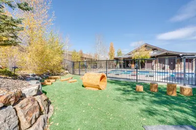 a yard with a fence and a pool with logs at Half-Mi to Skiing Gorgeous Granby Ranch Home! in Granby