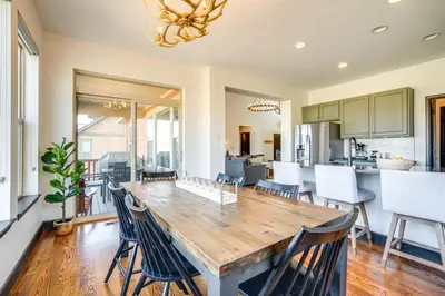 a kitchen and dining room with a wooden table and chairs at Half-Mi to Skiing Gorgeous Granby Ranch Home! in Granby