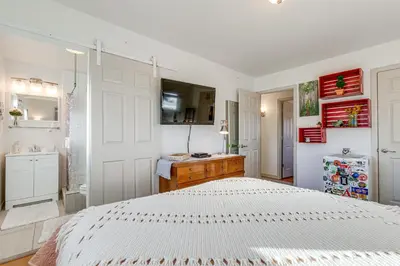 a bedroom with a white bed and a sink at 4 Mi to Hwy Access for Mtn Fun Family Getaway! in Lakewood