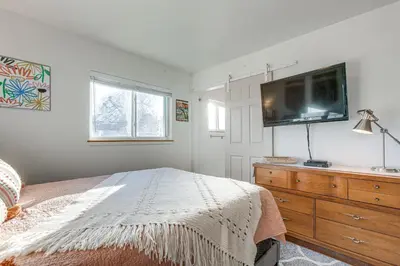 a bedroom with a bed and a flat screen tv at 4 Mi to Hwy Access for Mtn Fun Family Getaway! in Lakewood