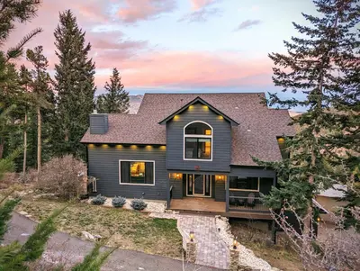 a gray house with a gambrel roof at Stay in Evergreen - Denver Mountain Escape in Evergreen