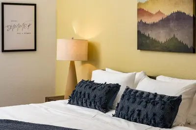 a bedroom with a bed with two pillows on it at Stay in Evergreen - Denver Mountain Escape in Evergreen