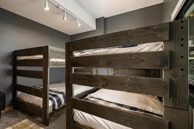 a bedroom with two bunk beds in a room at Stay in Evergreen - Denver Mountain Escape in Evergreen